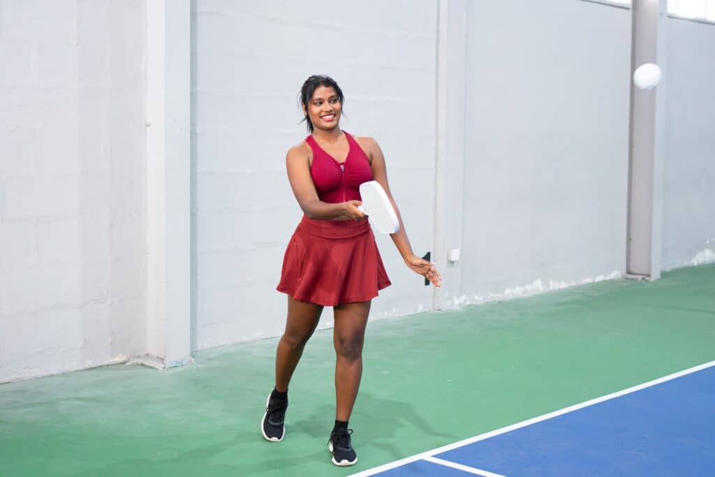 Fit woman playing pickleball as part of her workout routine