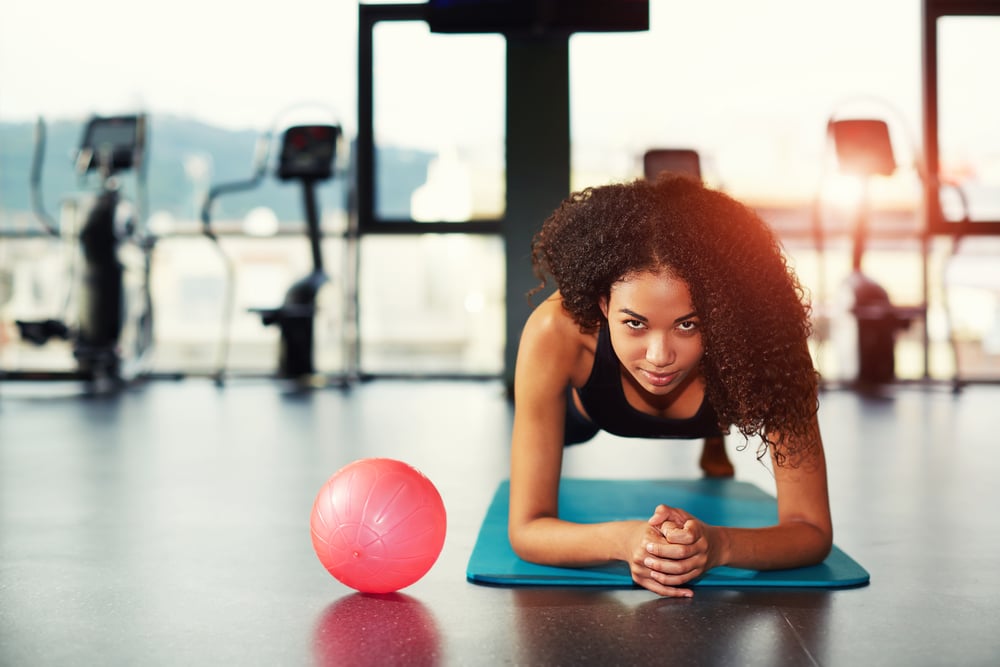 Woman doing a plank at the gym